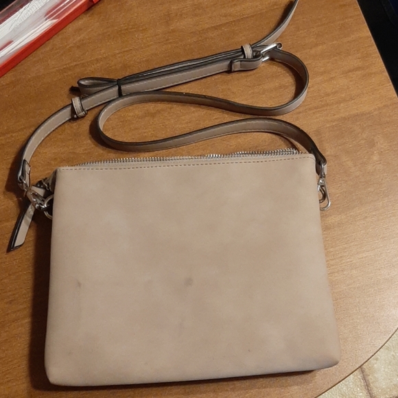 Tan purse with black accents along edges. - Picture 2 of 6
